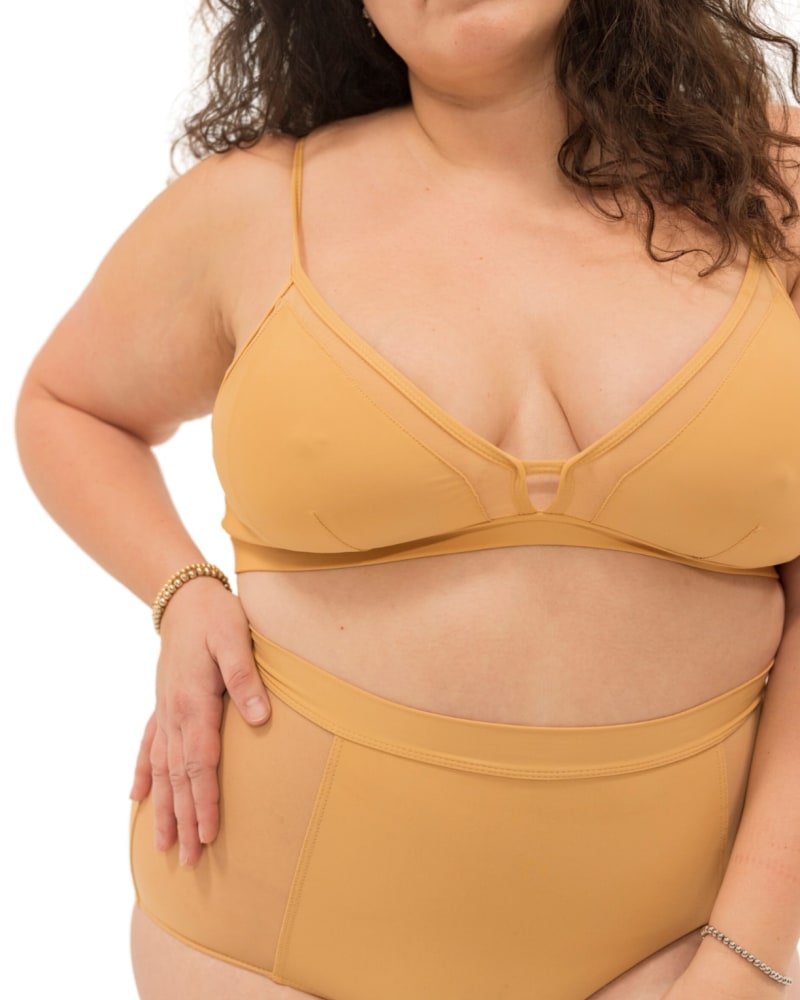 Front of a model wearing a size 3X Nude Shade Full Coverage Bralette in Crème by Naked Rebellion. | dia_product_style_image_id:327958